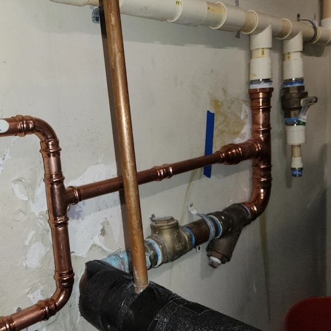 A copper set of pipes in a residential home.