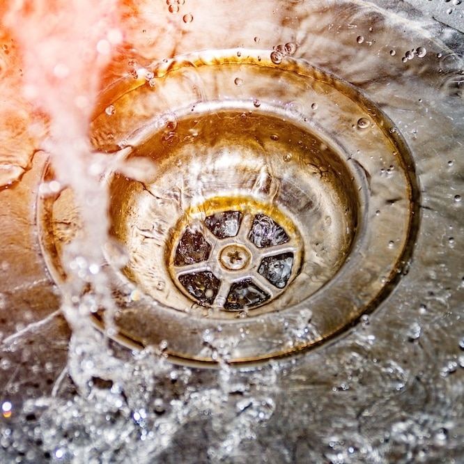 Water flowing down drain.